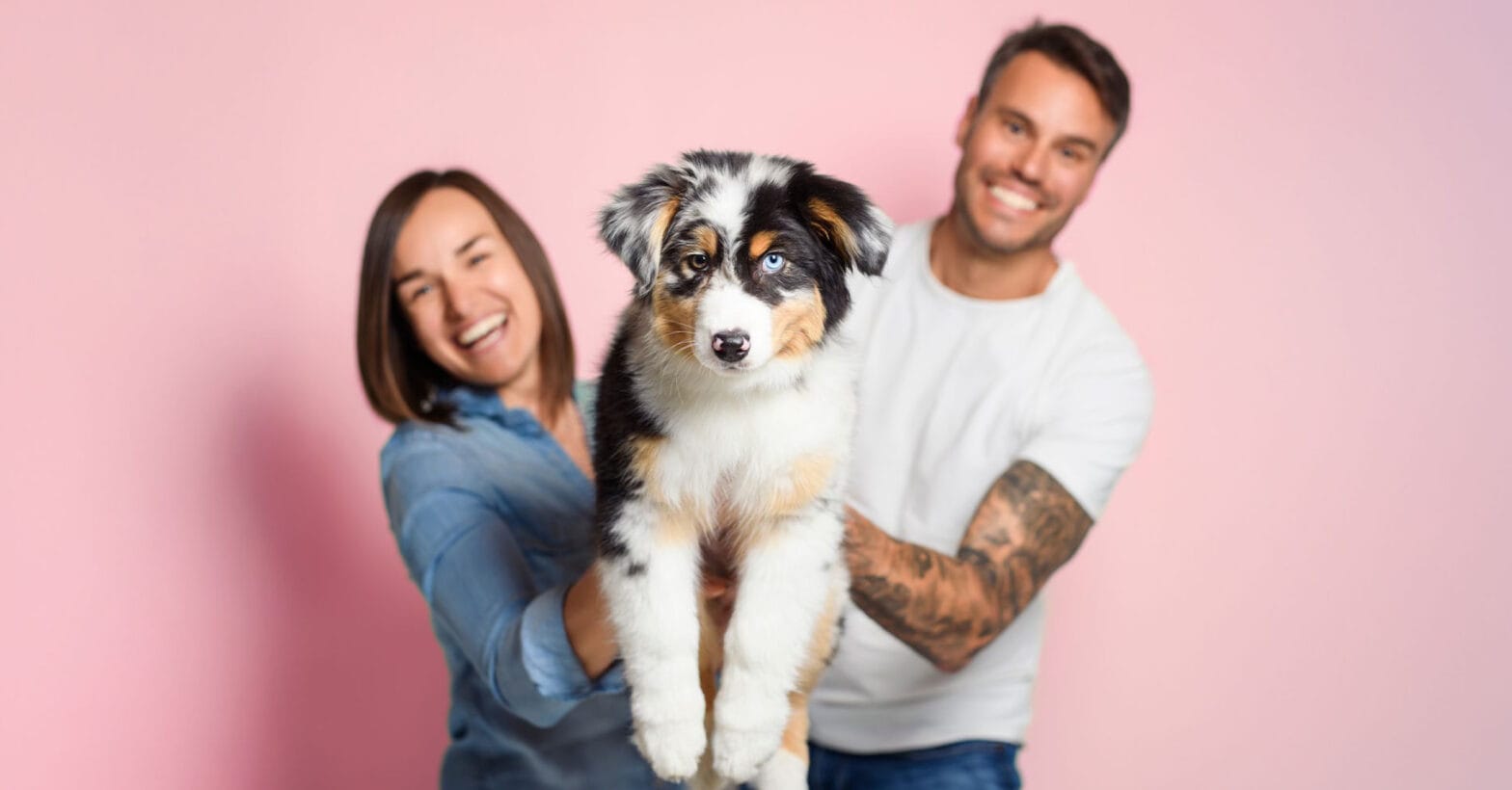 Couple holding a fluffy puppy